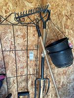 Overall view showing spade, fork, rake head, trellis, hanging planters