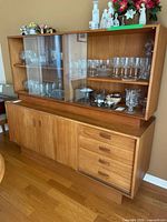 Full view of hutch showing upper glass display and lower drawers/cabinet