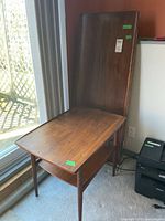 End table with coffee table top leaning behind