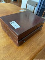 Closed wooden presentation chest showing exterior condition
