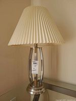 Full view of first table lamp with shade and base