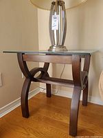 End table front view with glass top, curved wood legs