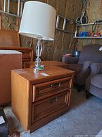 Nightstand with lamp showing overall design and drawer fronts