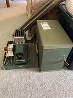 Projector, case, cords, slide changer, tripod stand overview