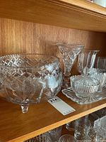 Large footed cut crystal bowl, stem goblets, ribbed sugar and creamer with underplate
