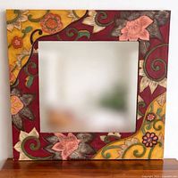 Front view showing entire floral carved wood frame and mirror