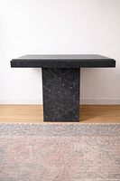 front view of black marble side table showing overall design