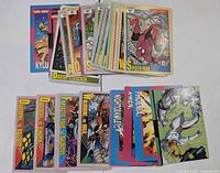 Overview of assorted card fronts in small stacks, Spider-Man visible on top