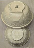 Two inverted TG Green bowls showing stamped bases and size difference