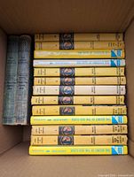 Box with majority of yellow-spine Nancy Drew books and two early cloth editions