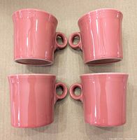 Four pink Fiesta mugs side view