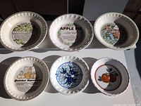Overview of six pie plates showing all graphics