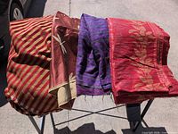 Four distinct fabric pieces draped over stand