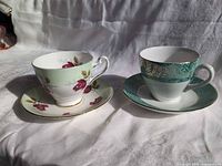 Both teacup and saucer sets side by side