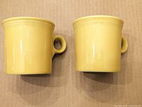 Top view of two yellow Fiesta mugs showing color and form