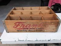 Side view showing Frank's logo, metal corner braces, and three-row divider