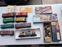 All rolling stock, spare parts, and original boxes laid out on table