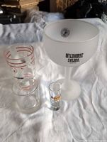 All four glasses grouped together showing size differences and logos