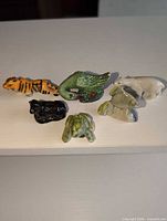 All six porcelain animal figurines grouped on surface
