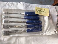 Front view of five blue-handled chisels in clear sleeve packaging