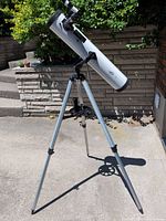 Full view of telescope on tripod outdoors