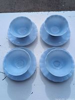 Top view of four bowl and saucer sets