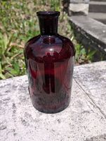 Front view of ruby red Pyrex bottle