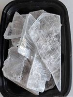 Top view of multiple translucent selenite pieces in a tray