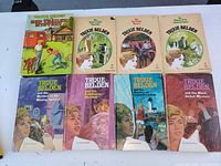 Front cover view of all seven Trixie Belden books