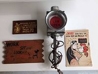 Overhead view showing bar lamp, two wooden plaques and rotating postcard