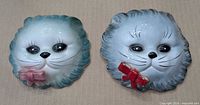 Both ceramic cat wall pockets, front view