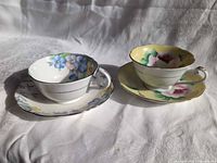 Both teacup and saucer sets side by side