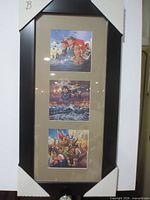 Full view of black wood frame with three prints under tan double mat