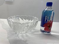 Bowl next to water bottle for scale