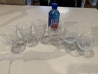 Six crystal glasses arranged on countertop