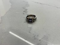 Ring front showing pale purple stone and gold accents