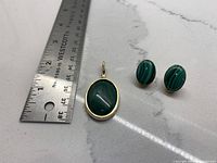 Pendant and earrings with ruler for scale