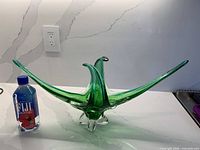 Full view of green-blue Chalet glass dish beside water bottle for scale