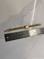 Full view of Seiko wristwatch alongside ruler for scale