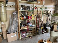 Full view of beige metal shelving unit with five shelves