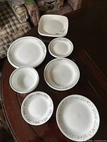 All eight ceramic pieces laid out showing shapes and rim patterns