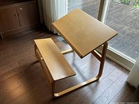 Full view of light wood children's desk with integrated bench