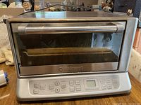 Front view of Cuisinart stainless steel toaster-convection oven showing control panel, door and handle