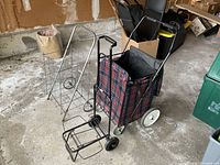 Overview of three carts: wire cart, plaid trolley, black hand truck