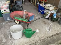 Group shot of wheelbarrow, watering can, planter pot, tools and kneeling pads