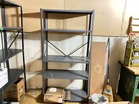 Front view of gray steel shelving unit showing five shelves and cross-brace