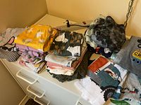 Folded stacks of children’s clothing on dresser