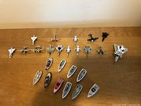 Top-down view of all planes and boats laid out on table