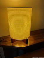Lamp lit showing fabric shade and wood base