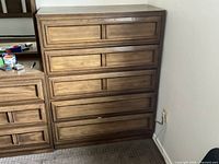 front view of five-drawer wood chest showing design and finish
